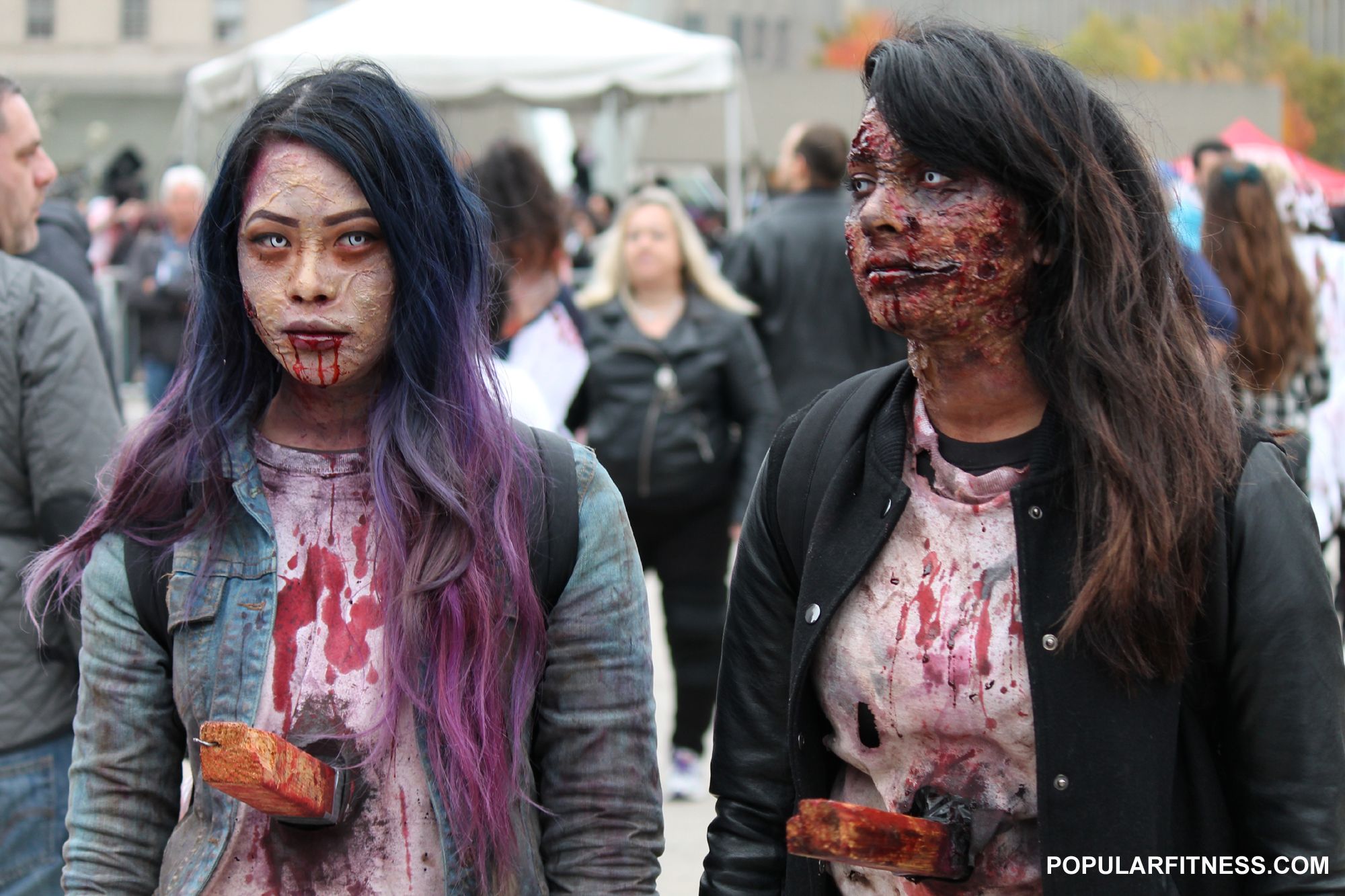 A couple of girls with stakes in their hearts at the 2014 Toronto Zombie Walk an